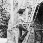 Slate roofer balancing tiles on his head